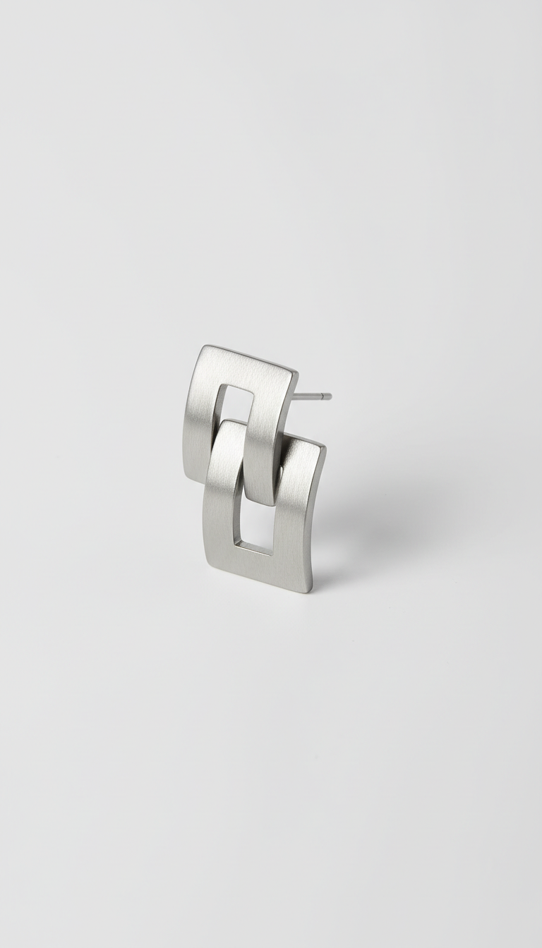 Modern steel earrings, Use a 3/4 angle for product shots, allowing the viewer to appreciate the depth and detail of the...